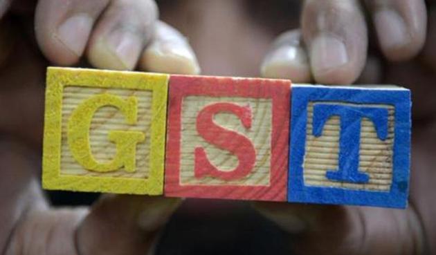 An Indian consumer goods trader shows letters GST representing "Goods and Services Tax" (GST)at his shop in Hyderabad. (AFP) An Indian consumer goods trader shows letters GST representing "Goods and Services Tax" (GST)at his shop in Hyderabad. (AFP)