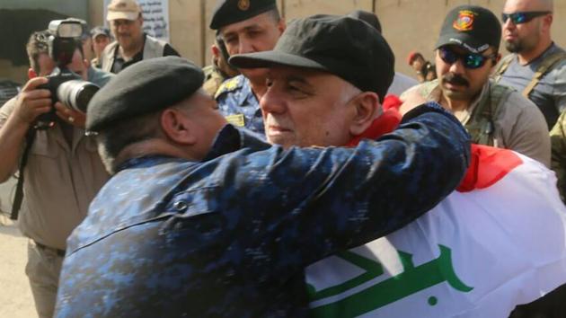 The prime minister joined hundreds of civilians in Mosul to celebrate the army’s gains over ISIL. (AFP) The prime minister joined hundreds of civilians in Mosul to celebrate the army’s gains over ISIL. (AFP)