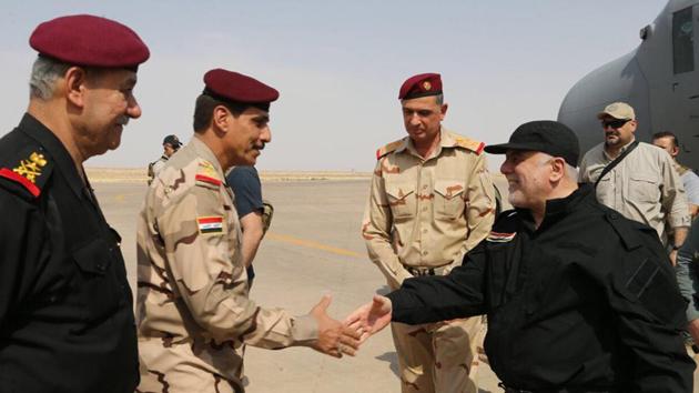 Iraqi Prime Minister Haider al-Abadi (R) shaking hands with police and army officers upon his arrival in Mosul. (AFP) Iraqi Prime Minister Haider al-Abadi (R) shaking hands with police and army officers upon his arrival in Mosul. (AFP)