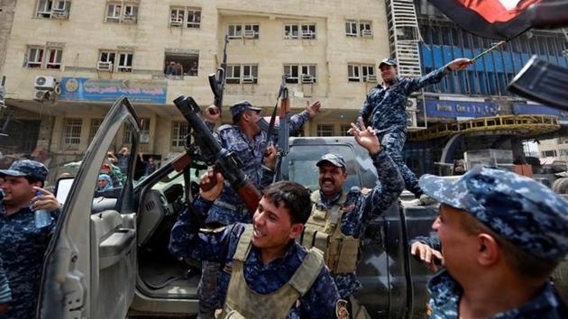 Iraqi Federal Police celebrate the victory in the Old City . (Ahmed Saad / Reuters) Iraqi Federal Police celebrate the victory in the Old City . (Ahmed Saad / Reuters)