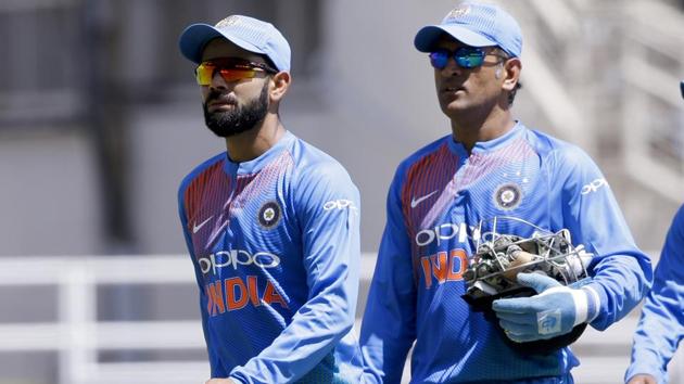 India captain Virat Kohli (L) and wicketkeeper MS Dhoni walk to the pavilion after losing to West Indies by 9 wickets a T20I at Sabina Park in Kingston, Jamaica, on Sunday.(AP)