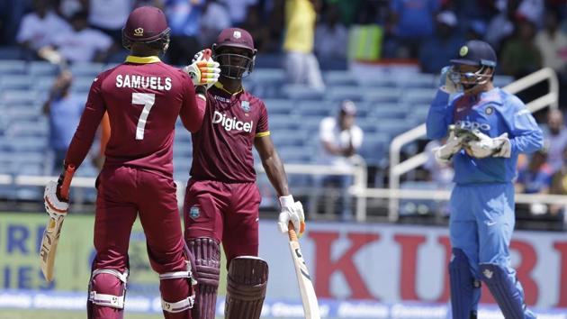 West Indies' Marlon Samuels and Evin Lewis celebrate beating India by nine wickets during the one-off T20I at Sabina Park in Kingston on Sunday.(AP)