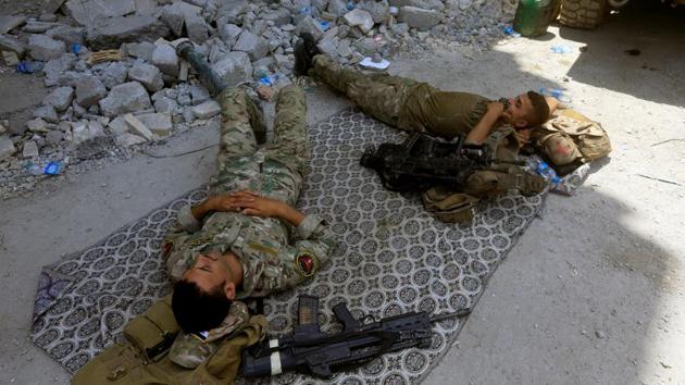Members of the Emergency Response Division rest in the Old City of Mosul. (Alaa Al-Marjani / REUTERS) Members of the Emergency Response Division rest in the Old City of Mosul. (Alaa Al-Marjani / REUTERS)