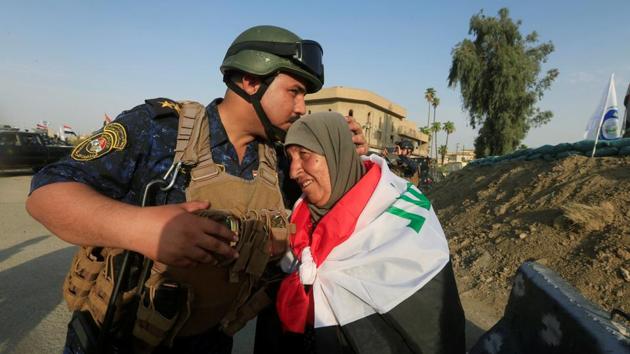 A member of Iraqi Federal police kisses an old woman in West Mosul, Iraq. (Alaa Al-Marjani / REUTERS) A member of Iraqi Federal police kisses an old woman in West Mosul, Iraq. (Alaa Al-Marjani / REUTERS)