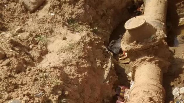 Residents dug up the ground to show the pipe that allegedly diverted water away from their area. Residents dug up the ground to show the pipe that allegedly diverted water away from their area.