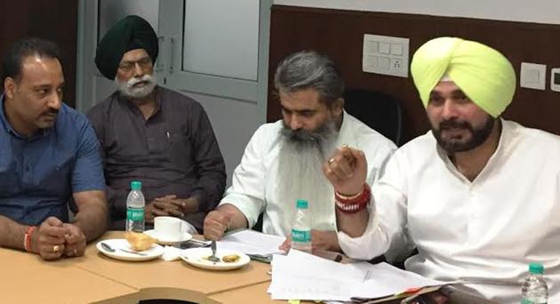 Local bodies minister Navjot Singh Sidhu at a public hearing of suspended SEs in Chandigarh on Tuesday. (HT Photo) Local bodies minister Navjot Singh Sidhu at a public hearing of suspended SEs in Chandigarh on Tuesday. (HT Photo)