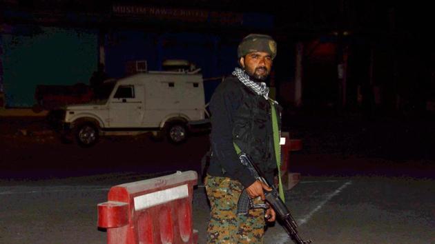 Security person stand guard after militants opened fire on a bus carrying Amarnath yatri in Anantnag.(PTI Photo)