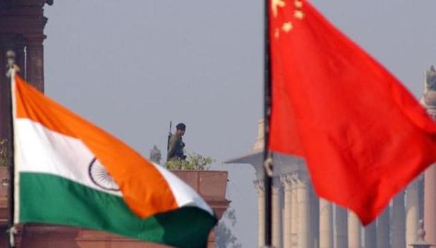 File photo of an Indian paramilitary trooper framed by Indian and Chinese flags near the presidential palace in New Delhi in January 2002. (AFP) File photo of an Indian paramilitary trooper framed by Indian and Chinese flags near the presidential palace in New Delhi in January 2002. (AFP)