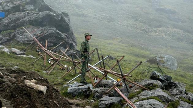 In this photograph taken on July 10, 2008, a Chinese soldier stands guard on the Chinese side of the ancient Nathu La border crossing between India and China. (AFP) In this photograph taken on July 10, 2008, a Chinese soldier stands guard on the Chinese side of the ancient Nathu La border crossing between India and China. (AFP)