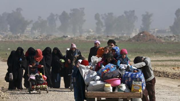 FILE - In this March 9, 2017 file photo, Iraqi civilians walk toward Iraqi security forces after fleeing their homes due to fighting between government forces and Islamic State militants, on the western side of Mosul, Iraq. (AP) FILE - In this March 9, 2017 file photo, Iraqi civilians walk toward Iraqi security forces after fleeing their homes due to fighting between government forces and Islamic State militants, on the western side of Mosul, Iraq. (AP)