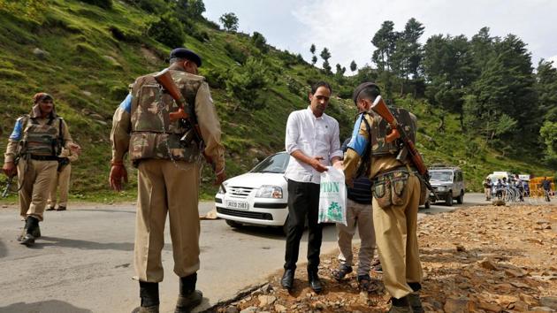 Security force personnel (R) checks the bag of a man near a base camp of Hindu pilgrimage to the cave of Amarnath after seven Hindu pilgrims were killed in a gunbattle between Indian police and militants on Monday.(REUTERS) Security force personnel (R) checks the bag of a man near a base camp of Hindu pilgrimage to the cave of Amarnath after seven Hindu pilgrims were killed in a gunbattle between Indian police and militants on Monday.(REUTERS)
