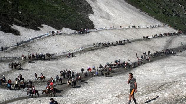 Pilgrims cross mountain trails during their religious journey to the Amarnath cave on the Baltal route, some 125 kms away from Srinagar. (PTI)
