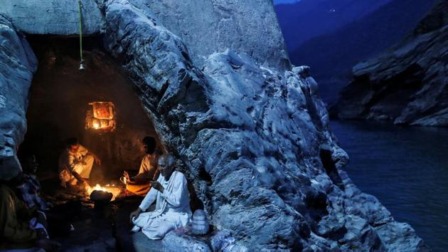 Priests sit inside a cave as they perform evening prayers on the banks of the river Ganga in Devprayag, Uttarakhand, the location of the confluence and renaming of two rivers into Ganga. (Danish Siddiqui / Reuters) Priests sit inside a cave as they perform evening prayers on the banks of the river Ganga in Devprayag, Uttarakhand, the location of the confluence and renaming of two rivers into Ganga. (Danish Siddiqui / Reuters)