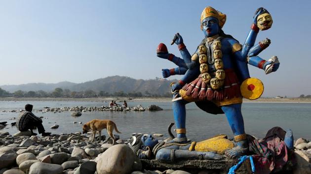 A man sits next to a damaged idol of the goddess Kali which was taken out after its immersion in the river Ganga in Haridwar, Uttarakhand. (Danish Siddiqui / Reuters) A man sits next to a damaged idol of the goddess Kali which was taken out after its immersion in the river Ganga in Haridwar, Uttarakhand. (Danish Siddiqui / Reuters)