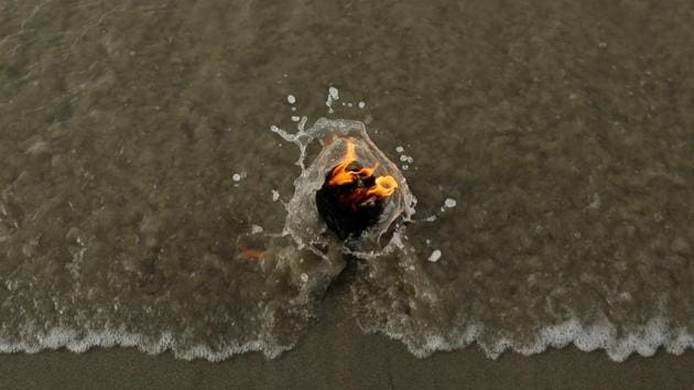A lamp lit by a pilgrim is seen at the confluence of the river Ganga and the Bay of Bengal, at Sagar Island, south of Kolkata, West Bengal. (Danish Siddiqui / Reuters) A lamp lit by a pilgrim is seen at the confluence of the river Ganga and the Bay of Bengal, at Sagar Island, south of Kolkata, West Bengal. (Danish Siddiqui / Reuters)