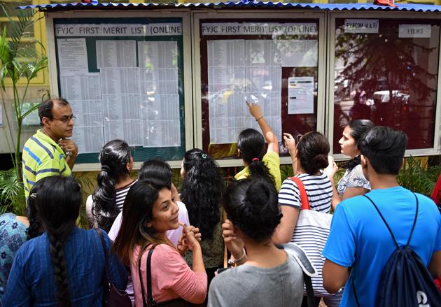 Students and parents look at the first lists put up outside HR College in Mumbai on Tuesday.(Satyabrata Tripathy/HT Photo)