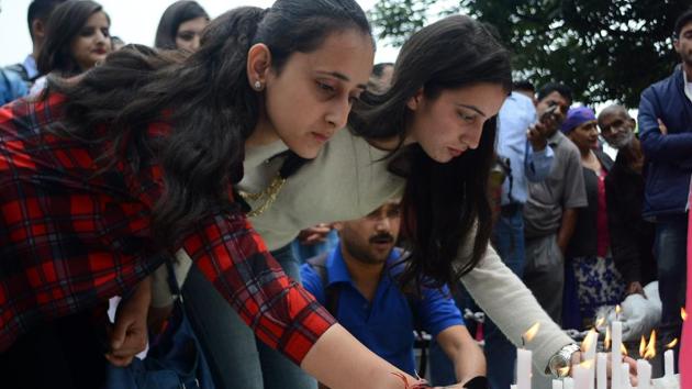 Locals light candles on the Ridge, Shimla, to protest the rape and murder of a minor girl on Wednesday. (Deepak Sansta/HT Photo) Locals light candles on the Ridge, Shimla, to protest the rape and murder of a minor girl on Wednesday. (Deepak Sansta/HT Photo)