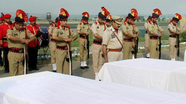 Police personnel pay tributes to the Amarnath Yatris who were killed in Monday's militants attack, at the airport in Srinagar on Tuesday.(PTI photo)