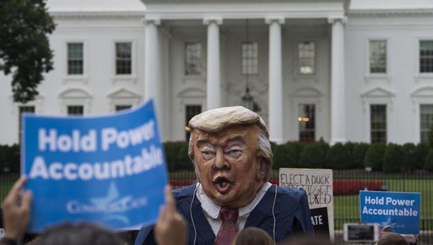 Protesters hold up signs near a US President Donald Trump puppet during a rally calling for accountability for the Trump campaign's alleged collusion with the Russian Government in front of the White House in Washington, DC on July 11, 2017. (AFP Photo) Protesters hold up signs near a US President Donald Trump puppet during a rally calling for accountability for the Trump campaign's alleged collusion with the Russian Government in front of the White House in Washington, DC on July 11, 2017. (AFP Photo)