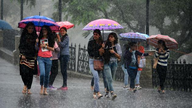 Locals strolling with umbrellas during heavy rainfall at Ridge, Shimla on Wednesday, July 12 2017. Photo by Deepak Sansta / Hindustan Times (Deepak Sansta/HT Photo)