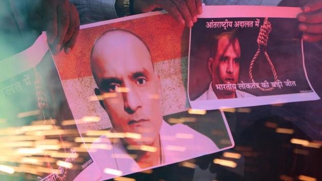 People in Ahmedabad hold posters of Kulbhushan Jadhav as they celebrate the International Court of Justice on order May 18, 2017. (Siddharaj Solanki / HT Photo) People in Ahmedabad hold posters of Kulbhushan Jadhav as they celebrate the International Court of Justice on order May 18, 2017. (Siddharaj Solanki / HT Photo)