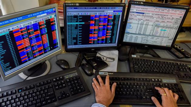A stockbroker trades shares on a terminal as the benchmark share index SENSEX crosses 32,000 points at a brokerage house in Mumbai. (Kunal Patil/HT Photo) 