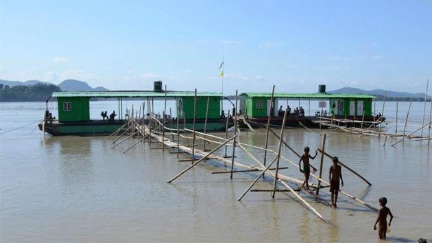 Children taking bath in a swollen Brahmaputra river at Kasomari Ghat in Guwahati on July 13. (PTI Photo) Children taking bath in a swollen Brahmaputra river at Kasomari Ghat in Guwahati on July 13. (PTI Photo)