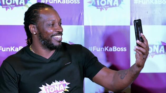 West Indies cricketer Chris Gayle takes a picture during a press conference in Bangalore on July 13.(AFP)