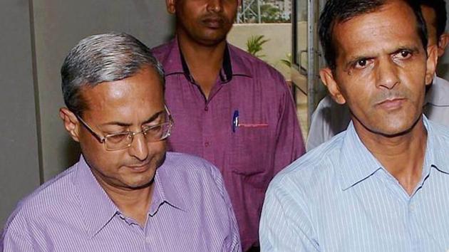Jharkhand’s principal commissioner of income tax Tapas Kumar Dutta (L) being detained by CBI officials for investigation in Ranchi on Wednesday. (PTI Photo) Jharkhand’s principal commissioner of income tax Tapas Kumar Dutta (L) being detained by CBI officials for investigation in Ranchi on Wednesday. (PTI Photo)