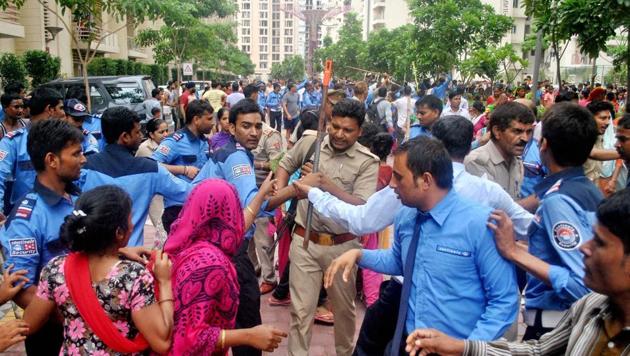 Residents of an apartment complex in Noida woke up to a riot-like situation on Wednesday morning, when a mob stormed its gates and vandalised the premises alleging that one of its residents had assaulted a domestic help. (PTI Photo) Residents of an apartment complex in Noida woke up to a riot-like situation on Wednesday morning, when a mob stormed its gates and vandalised the premises alleging that one of its residents had assaulted a domestic help. (PTI Photo)