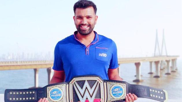 Rohit Sharma posing with the customised WWE belt sent to him by Triple H.(Twitter)