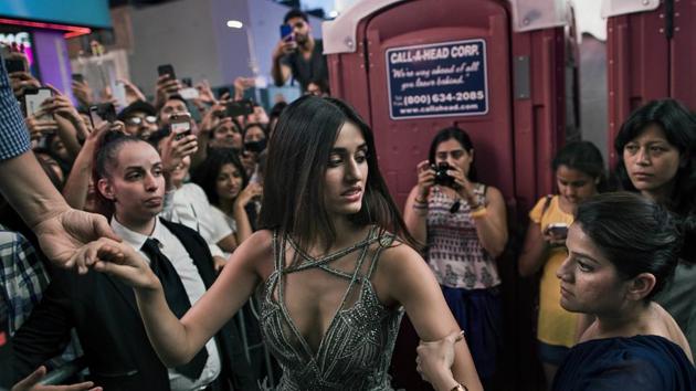 Disha Patani is held as she makes her way to the stage during The 18th edition of the International Indian Film Academy (IIFA) awards weekend event at Times Square. (AP)