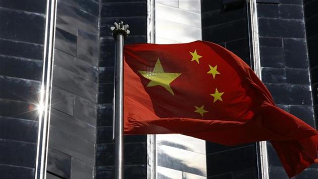 A Chinese flag is hoisted outside a commercial building in Shenzhen, China's southern Guangdong province. (Reuters File) A Chinese flag is hoisted outside a commercial building in Shenzhen, China's southern Guangdong province. (Reuters File)