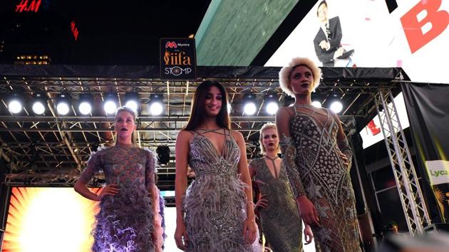 Disha Patani (C) and other models present outfits during the IIFA Stomp in Times Square. (AFP)