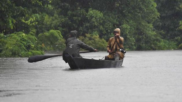 Indian forest guards seen out on patrol on a boat at Kaziranga National Park, about 250 kilometres east of Guwahati. (Biju BORO / AFP)