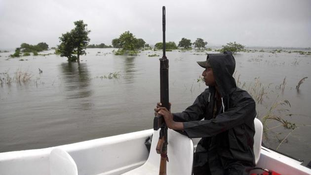 A forest guard patrols in a speed boat as the risk of poaching increases during floods. Animals such as rhinoceros, deer and buffalo move to higher ground to escape floods inundating the Indian preserve. Kaziranga National Park has the world's largest population of the one-horned rhinoceros and is home to many other wildlife. (Anupam Nath / AP)