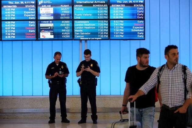 US Customs and Immigration officers keep watch at the arrivals level at Los Angeles International Airport on June 29, 2017. (Reuters) US Customs and Immigration officers keep watch at the arrivals level at Los Angeles International Airport on June 29, 2017. (Reuters)