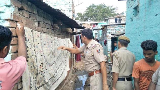 Police officials covering the defacement at Colony number 4 in Industarial Area, Chandigarh, on Saturday. (HT Photo) Police officials covering the defacement at Colony number 4 in Industarial Area, Chandigarh, on Saturday. (HT Photo)