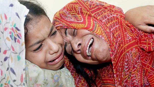 L-R) Daughter Kajol and wife Neha Devi of Lance Naik Ranjit Singh wail at the loss of Singh at their residence in Bhalwal village in Jammu on Thursday. Singh was among the two soldiers killed yesterday as Pakistani troops violated the ceasefire along the Line of Control (LoC) in Kashmir in Kupwara district. (PTI) L-R) Daughter Kajol and wife Neha Devi of Lance Naik Ranjit Singh wail at the loss of Singh at their residence in Bhalwal village in Jammu on Thursday. Singh was among the two soldiers killed yesterday as Pakistani troops violated the ceasefire along the Line of Control (LoC) in Kashmir in Kupwara district. (PTI)