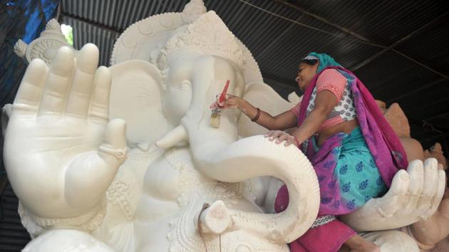 An Indian artist paints an idol of the Hindu deity Ganesh at a workshop in Hyderabad. (Mukhtar Khan / AFP) An Indian artist paints an idol of the Hindu deity Ganesh at a workshop in Hyderabad. (Mukhtar Khan / AFP)