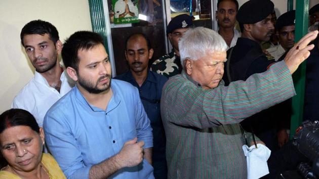RJD chief Lalu Prasad with his wife Rabri Devi, son and deputy CM Tejashwi Yadav and Tej Pratap Yadav at a press conference at his residence in Patna on Friday after CBI raids at his premises. (PTI) RJD chief Lalu Prasad with his wife Rabri Devi, son and deputy CM Tejashwi Yadav and Tej Pratap Yadav at a press conference at his residence in Patna on Friday after CBI raids at his premises. (PTI)