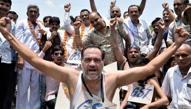 Cloth traders protest against the Goods and Services Tax (GST) at district collector's office in Bikaner on Saturday. (PTI) Cloth traders protest against the Goods and Services Tax (GST) at district collector's office in Bikaner on Saturday. (PTI)