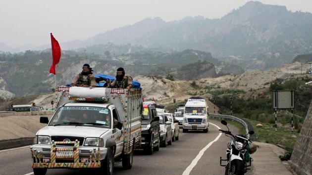 A security vehicle escorts a group of Amarnath pilgrims, on way to the holy shrine, at Jammu-Srinagar national highway.(PTI File Photo)