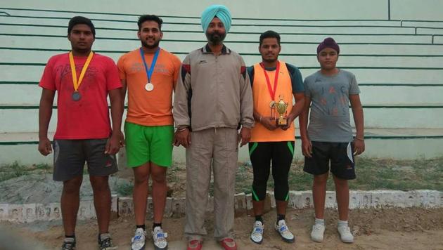 Hammer throw coachSukhraj Singh Batth with his wards. (HT sports) Hammer throw coachSukhraj Singh Batth with his wards. (HT sports)