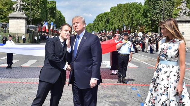 French President Emmanuel Macron (L) shakes hands with US President Donald Trump, next to US First Lady Melania Trump, during the annual Bastille Day military parade on the Champs-Elysees avenue in Paris. (AFP) French President Emmanuel Macron (L) shakes hands with US President Donald Trump, next to US First Lady Melania Trump, during the annual Bastille Day military parade on the Champs-Elysees avenue in Paris. (AFP)