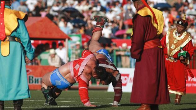 Mongolian wrestlers fight during the traditional Nadaam festival in Ulan Bator. (AFP) Mongolian wrestlers fight during the traditional Nadaam festival in Ulan Bator. (AFP)