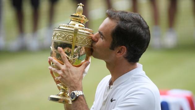 Roger Federer poses with the trophy as he celebrates winning the Wimbledon final against Marin Cilic. (REUTERS)