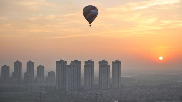 A hot air balloon flies over residential buildings in Wuqing District of Tianjin, China. (REUTERS) A hot air balloon flies over residential buildings in Wuqing District of Tianjin, China. (REUTERS)