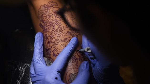 A tattoo artist fills in an intricate design at a workshop in Dadar. (Satyabrata Tripathy/HT Photo)