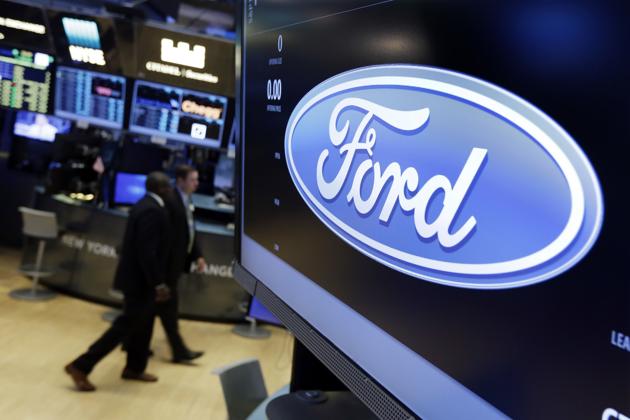 The logo for the Ford Motor Company appears above a post on the floor of the New York Stock Exchange.(AP File Photo)